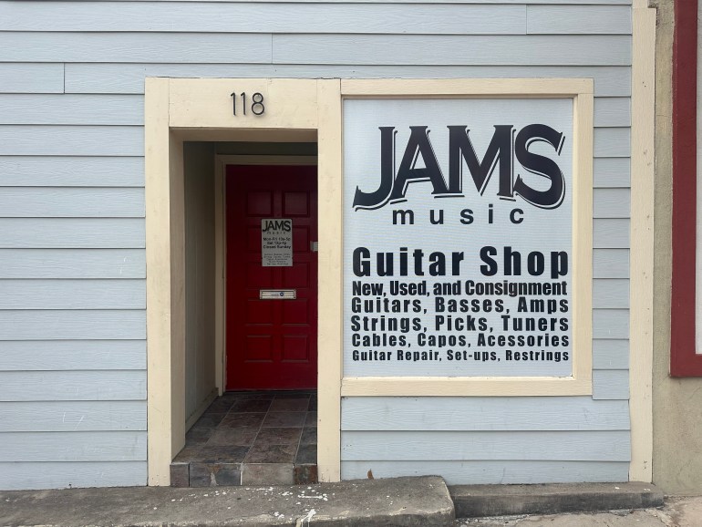 "JAMS Music-- Guitar shop" sign outside the entrance