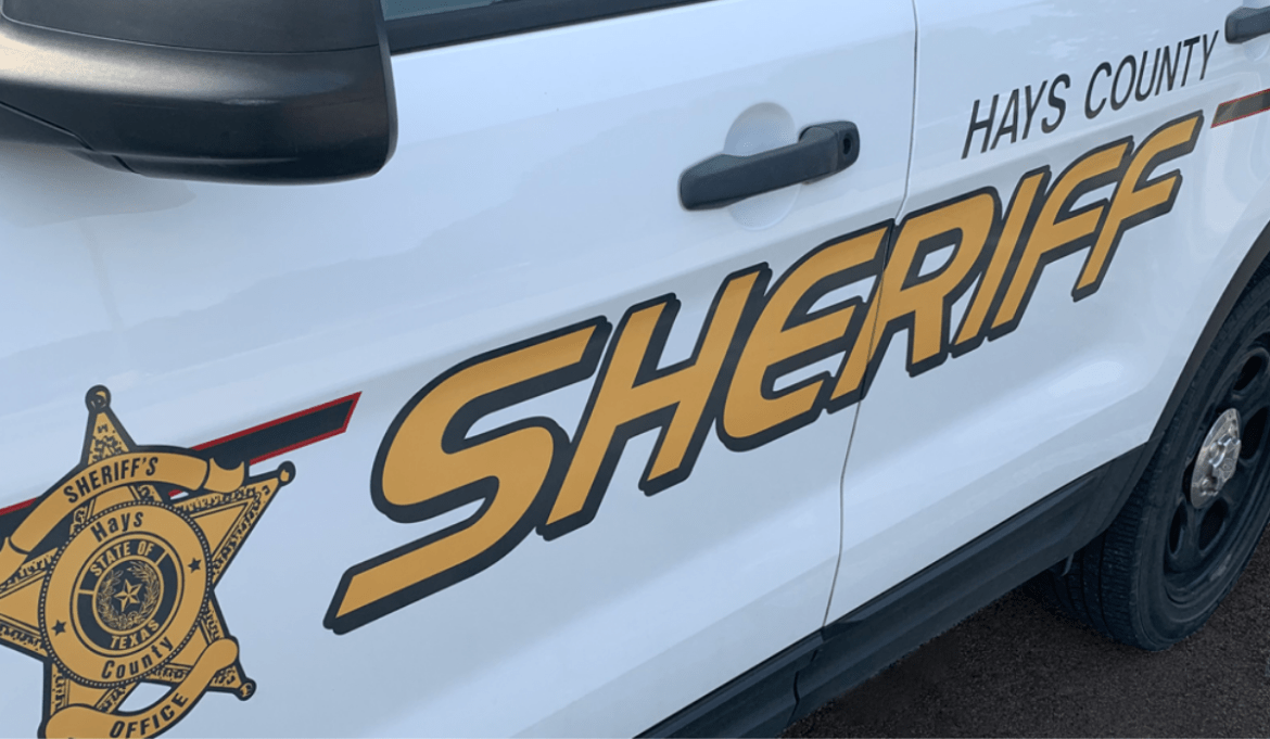 Hays County Sheriff's Office police car parked, showing the HCSO official logo and "Hays County Sheriff" printed on the side.