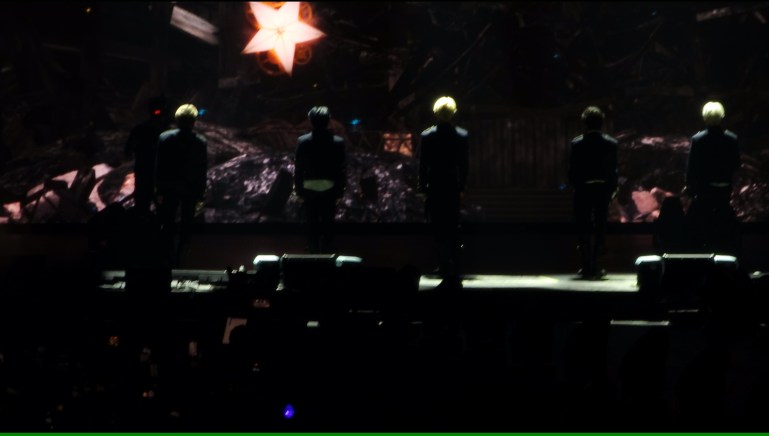 Tomorrow by Together members facing their backs to the audience as they look at the singular star animation in the LED screen.  