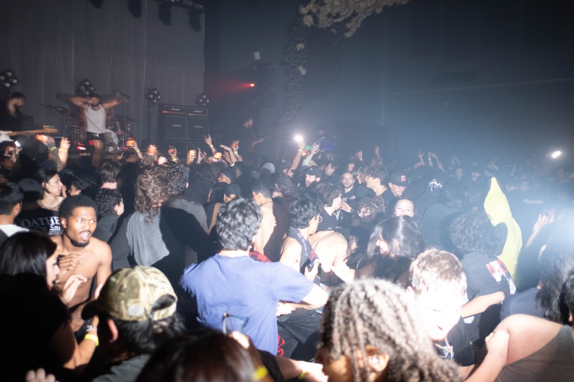 A crowd at Loathe’s sold-out Austin show, fans participating in a mosh pit inside the venue.