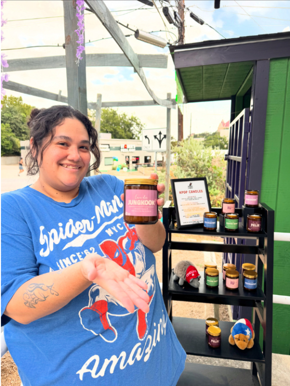Sarah holds a K-pop themed candle that the shop offers alongside its specialty drinks.