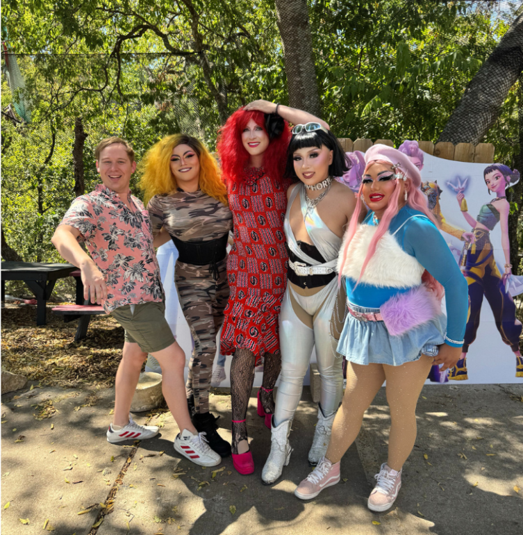 John poses with the Drag Queens.