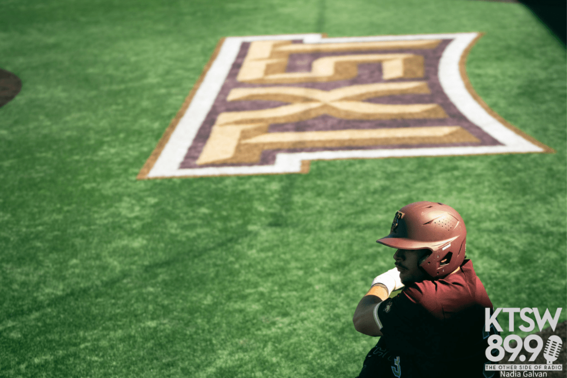 A Texas State player is seen preparing to step into the batters box.