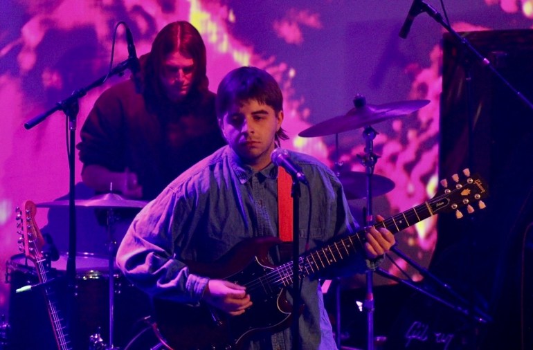 two members of Amelia's Best Friend, Travis Norton and Logan Krupovage, up on stage