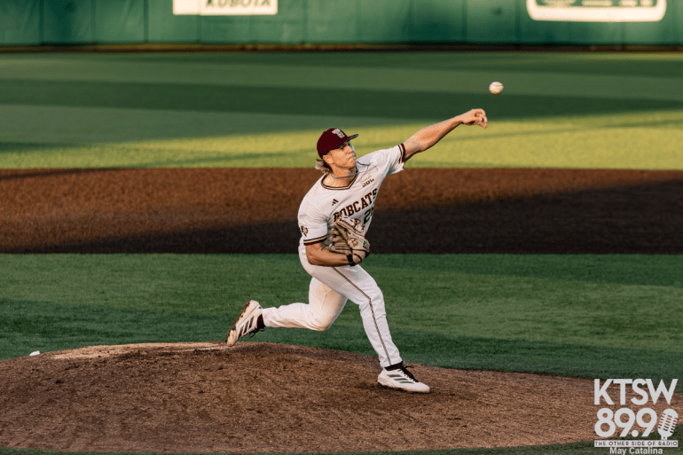 Texas State pitcher wearing a white jersey throws a pitch from the mound.