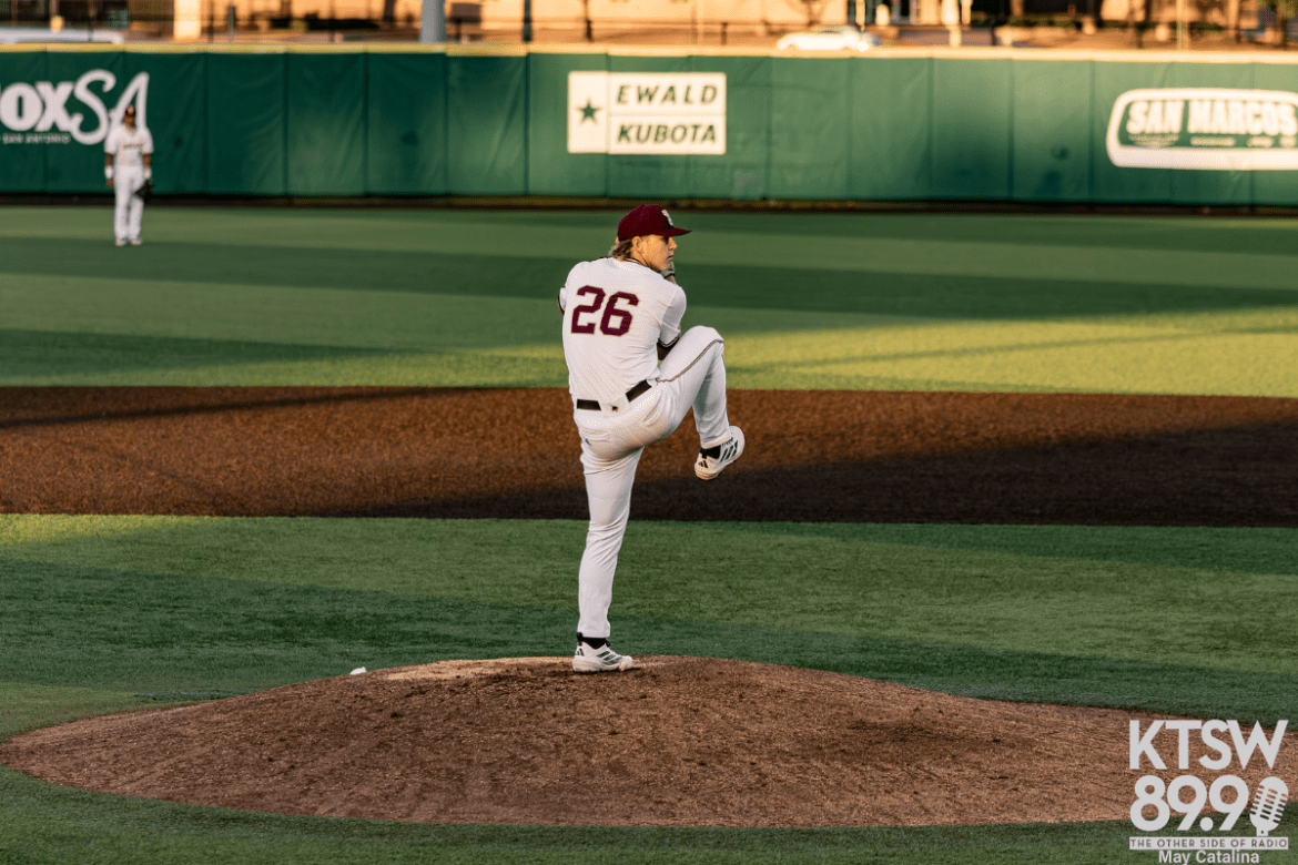 Texas State pitcher Nolan Moore winds up for a pitch on the mound.