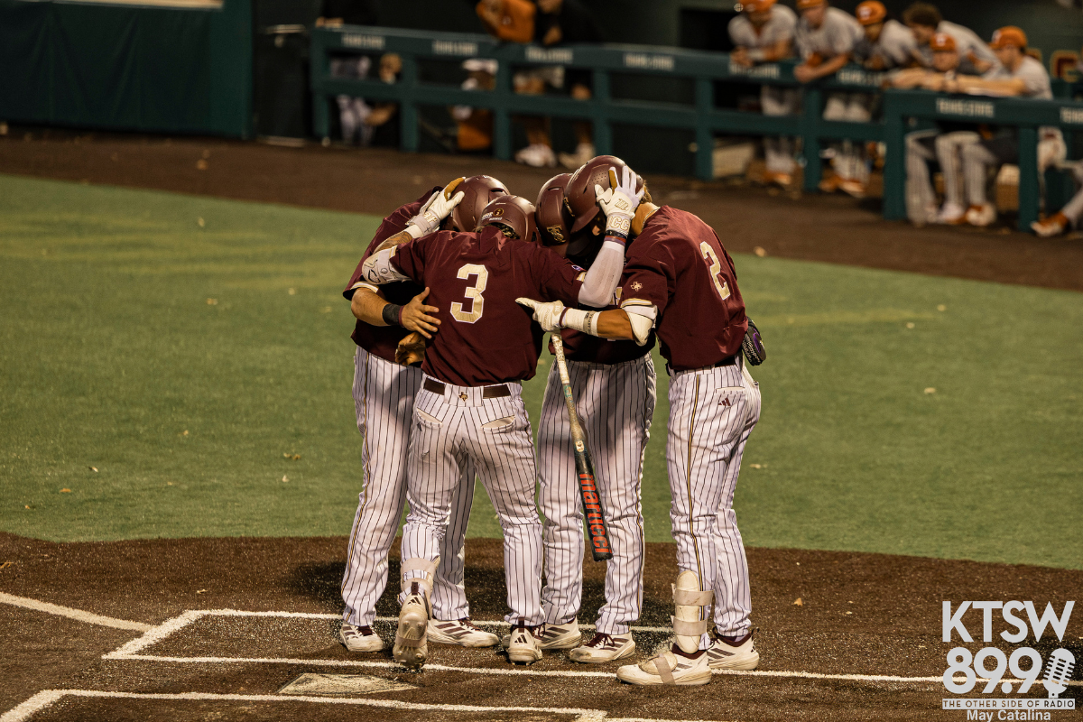 Players celebrate at home plate after Dawson Park hits a three run homerun.
