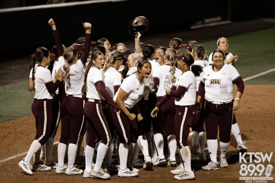 Texas State players celebrate after scoring a run.