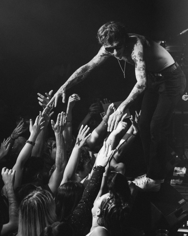 Lead vocalist, Alex Alvarez reaching out into the crowd of fans