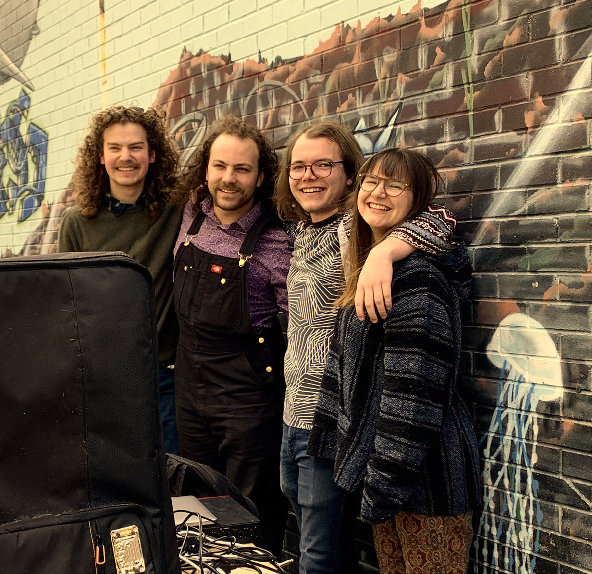 The band, Hover, from Austin Tx, leaned against a wall.