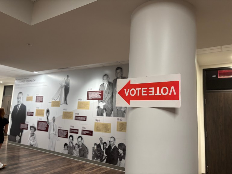 "VOTE" sign posted inside the LBJ Student Center on a pillar pointing to the polling room hallway. 