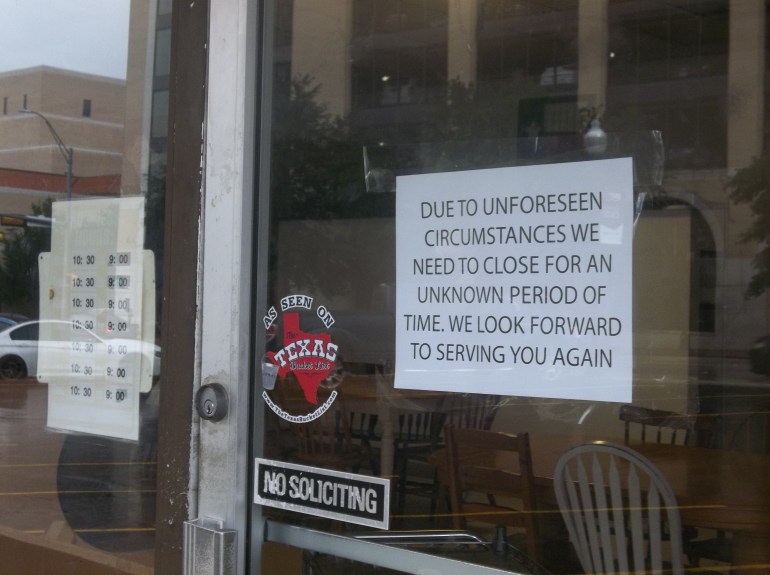 The printed notice on the store's door announces temporary closure of Alvin Ord's. 