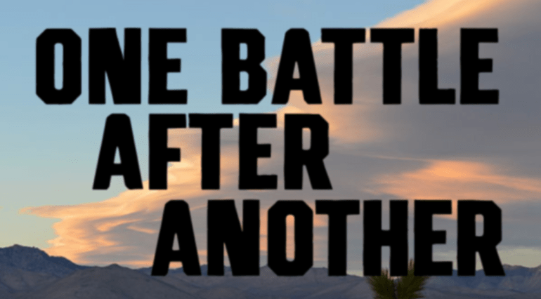 “One Battle After Another” Text in front of sunset-drenched clouds