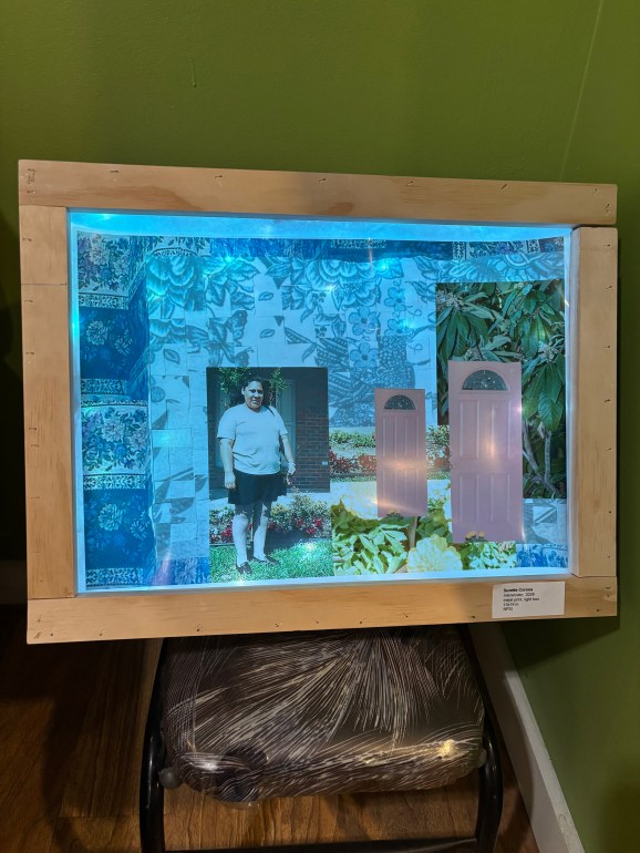 A light box that holds an art work collage of old family photos and current photography.