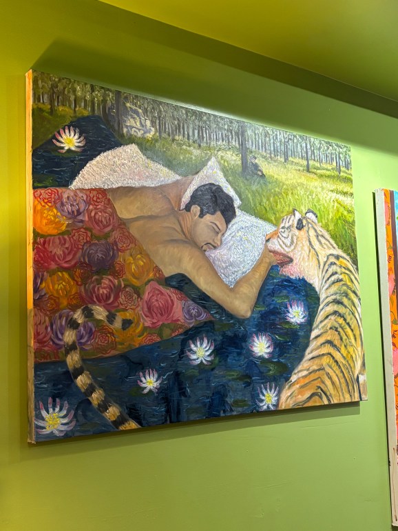 A painting with a man sleeping at a park on his stomach while a tiger creeps near him with a bloody mouth. 