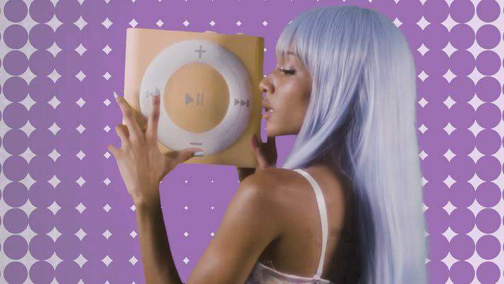 Cannelle Ferragu holds up enlarged yellow iPod Shuffle with a purple dotted background.