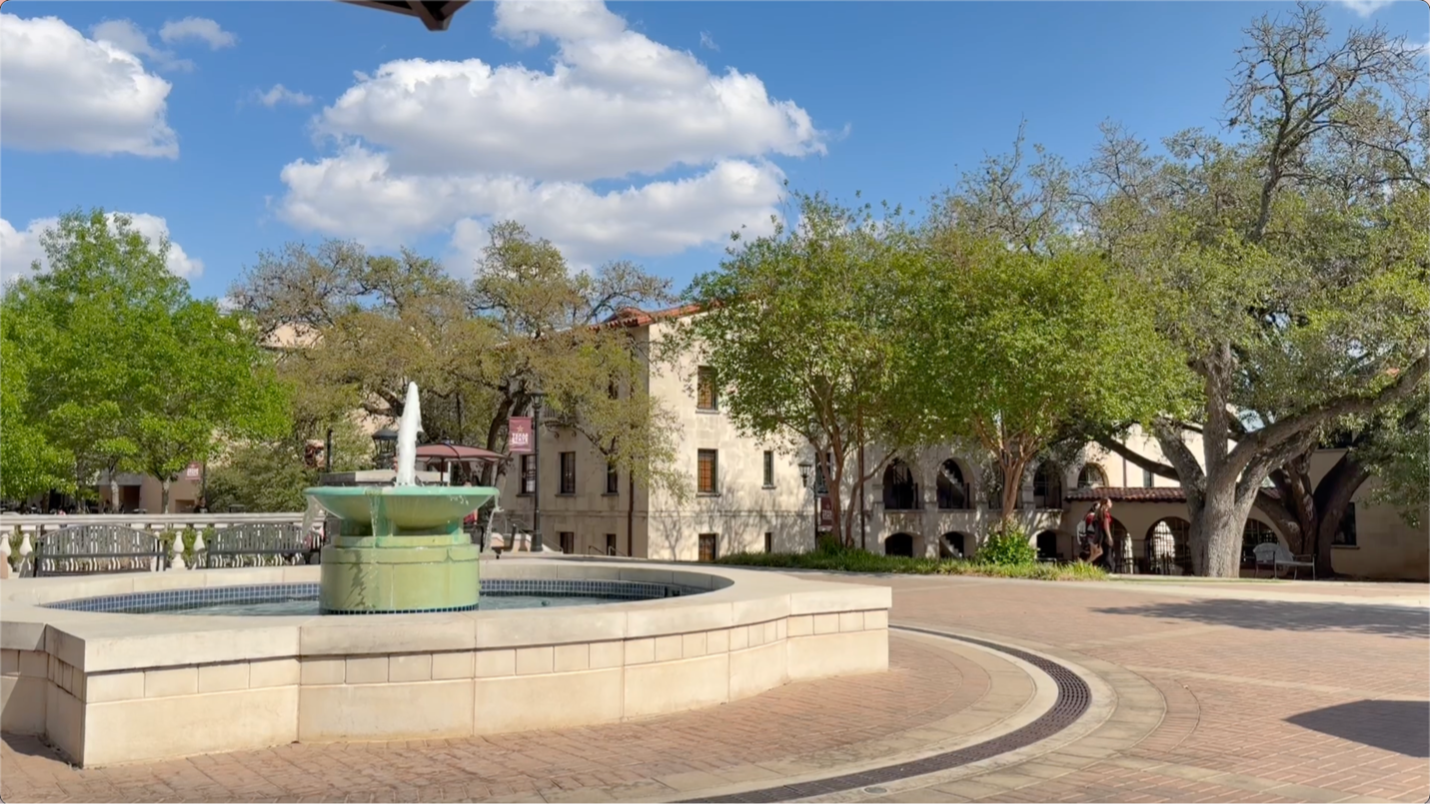 The fountain between Flowers Hall and Commons Dining Hall, during the daytime, with flowing water.