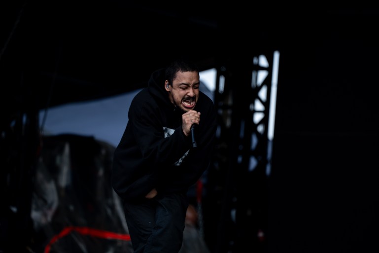 Dijon Duenas singing on stage at APE (All Points East)