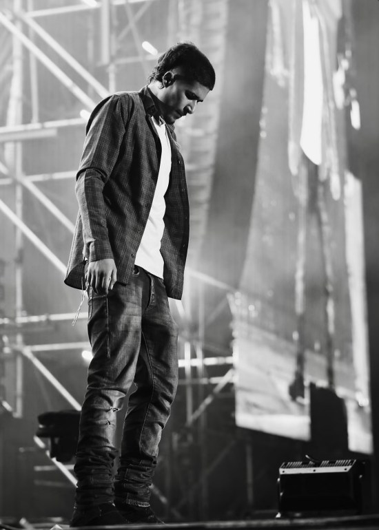 the image depicts UK rapper fake mink as he is standing on stage looking down on the crowd