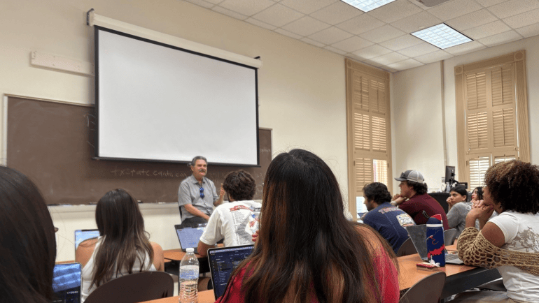 Bill Schoening {Man} speaks to a sports media class in a classroom at Texas State University.
