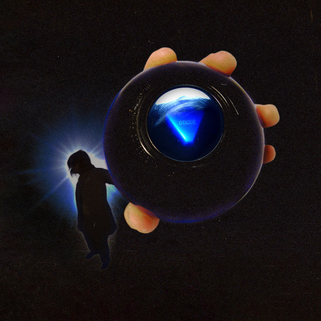 Album cover for Djo’s 2022 album, DECIDE. The image has a black background with the outline of lead singer, Joe Keery, with and enlarged hand holding a magic eight ball that says ‘DECIDE’. Behind the silhouette is a blue light. The image has a hazy filter.