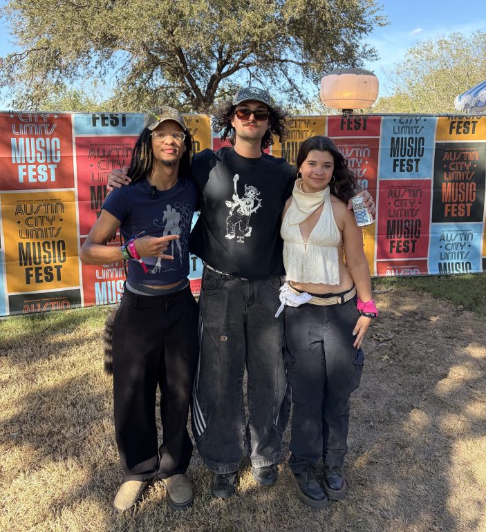 The image depicts Ethan and Rosalyn of KTSW, with the lead singer of Rum Jungle standing together in the ACL press lounge 