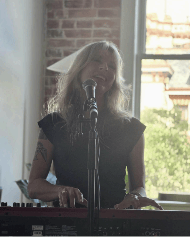 Emily Shirley playing the piano and singing at The Get Up gallery on September 18,2026