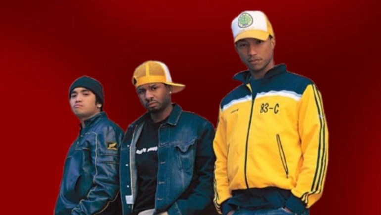 N.E.R.D. members Chad Hugo, Shay Haley, and Pharrell Williams posing on a red background
